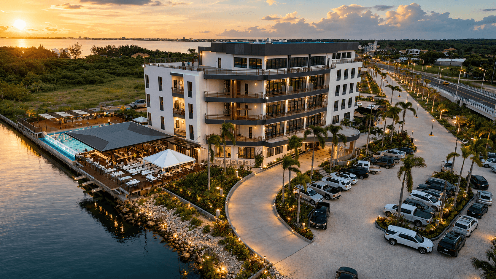 Grand Resort & Residences exterior with palm-lined driveway in Belize City